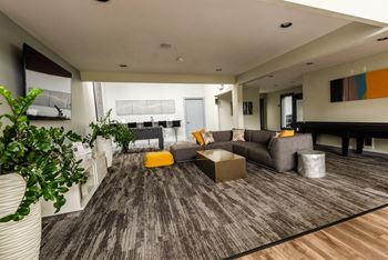 a large living room with a couch and a table